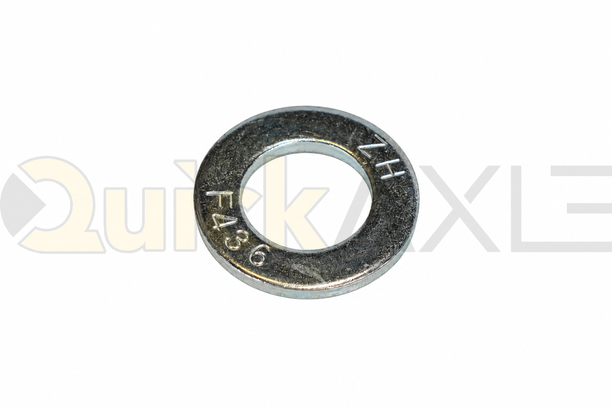 Flat washers arranged to show their central openings and stamped markings.