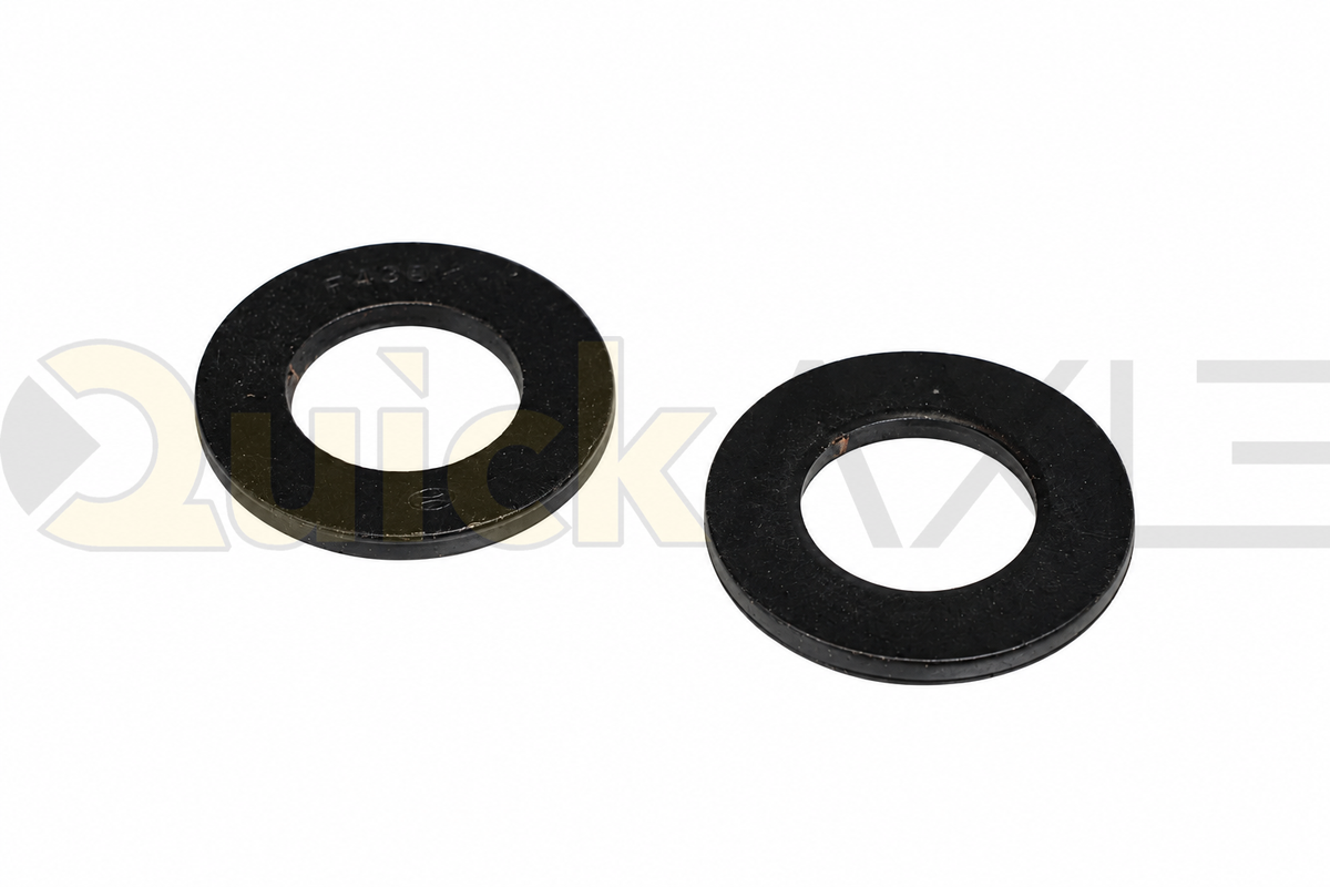 Flat black circular wear washers showing their central openings.
