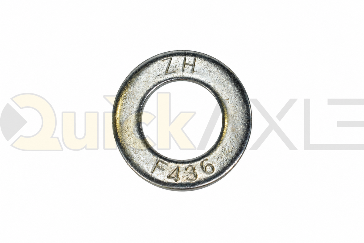 Flat washers arranged to show their central openings and stamped markings.